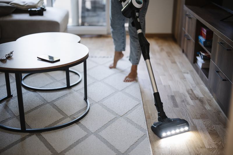 Person vacuuming a home floor